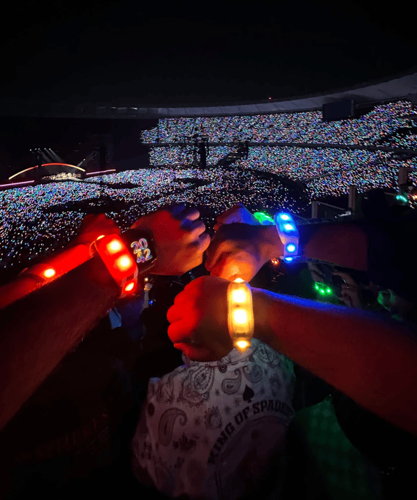 Wristbands glowing at a Coldplay stadium show